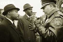 Albany, Georgia, police chief Laurie Prichett tells Martin Luther King Jr, left, and Dr. W.G. Anderson, center, that they are under arrest since they could not produce a permit to parade.