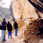 Visitors admiring trailside cliff dwelling