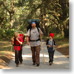 A father and two sons walk along