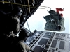 U.S. Air Force Senior Airmen Geoffery Koppel and Justin Gielski, loadmasters assigned to the 71st Search and Rescue Squadron out of Moody Air Force Base, Ga., push out a Zodiac boat bundle while in flight during a pararescue training jump aboard an HC-130 aircraft over Djibouti March 13, 2008.