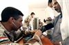 An Iraqi army medic takes a patient's blood pressure during a combined medical effort in Bata, Iraq, March 17, 2008. 