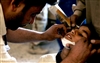 A local doctor bandages a boy's chin during a combined medical effort in Bata, Iraq, March 17, 2008. 