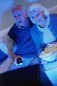 elderly couple watching television