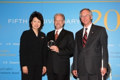 Secretary of Labor Elaine L. Chao (L) and Assistant Secretary of Labor for Disability Employment Policy W. Roy Grizzard (R) present a 2006 Secretary of Labor's New Freedom Initiative Award to T. Alan Hurwitz, Ed. D., CEO and Dean, National Technical Institute for the Deaf. (DOL Photo/Shawn Moore)