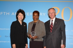 Secretary of Labor Elaine L. Chao (L) and Assistant Secretary of Labor for Disability Employment Policy W. Roy Grizzard (R) present a 2006 Secretary of Labor's New Freedom Initiative Award to Daisy M. Jenkins, Vice President, Human Resources, Raytheon Missile Systems, Raytheon Company, Highmark Inc. (DOL Photo/Shawn Moore)