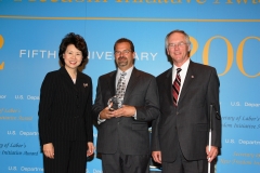 Secretary of Labor Elaine L. Chao (L) and Assistant Secretary of Labor for Disability Employment Policy W. Roy Grizzard (R) present a 2006 Secretary of Labor's New Freedom Initiative Award to Rick Kresslein, East Region Manager, PRIDE Industries. (DOL Photo/Shawn Moore)