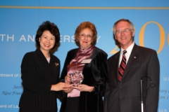 Secretary of Labor Elaine L. Chao (L) and Assistant Secretary of Labor for Disability Employment Policy W. Roy Grizzard (R) present a 2006 Secretary of Labor's New Freedom Initiative Award to Ilene Sambur-Morris. (DOL Photo/Shawn Moore)