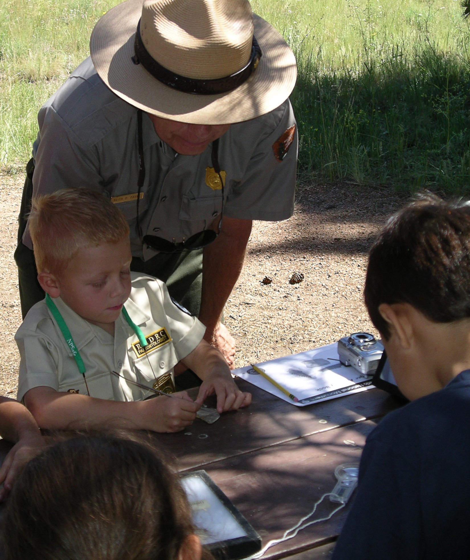 Park ranger instructs junior ranger in paleontology activity
