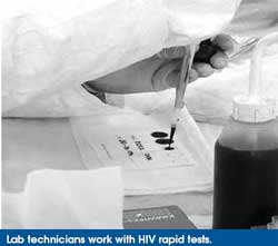 Lab technicians work with HIV rapid tests.