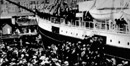historic photo of a steamship surrounded by a crowd at the docks in Seattle