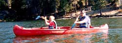 [Photograph]: A father and son canoeing.