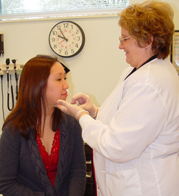 Photo of woman receiving a dose of FluMist.