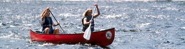 Two women maneuver their canoe for the next rapid