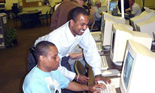 Image of a man and young adult on the computer