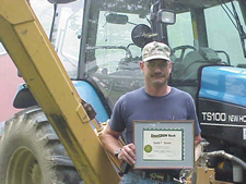 Image of a man holding a certificate