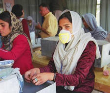 Image of a young women working with masks on