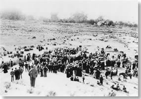 historic photo looking down a hill at a large group of people