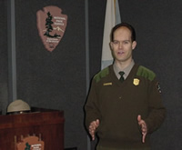 Ranger speaking in front of group in auditorium.