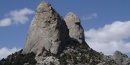Twin Sisters granite spires against a summer sky.