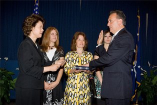 Secretary Elaine L. Chao administers the Oath of Office to Neil Romano