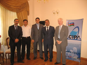 USAID/Azerbaijan economist, Dr. Paul Davis (right) poses with newly awarded Certified Accounting Practitioners.