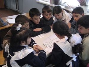In the Third Grade Program, students often work in groups, as it encourages open discussion about their opinions and ideas. Here, students are working together to identify the similarities and differences between moral rules and legal rules.