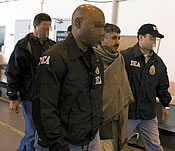 photo - Narco-terrorist, Baz Mohammad being taken away by DEA Agents