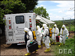 Mexican authorities, in protective hazmat suits, prepare to enter the methamphetamine superlab.