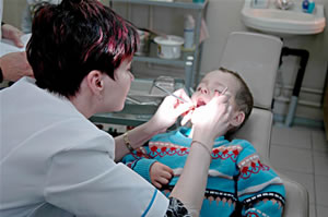 A Dentist examines a child