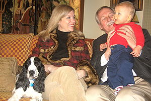 Congressman Snyder holds his son Penn while his wife, Reverend Betsy Singleton looks on.