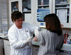 A nurse gives a patient a shot.