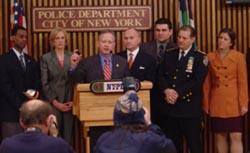 SAC Gilbride showing the New York press what a heroin pellet looks like at the press conference for Operation Bronx Tale.