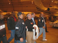 DEA agents escort Manuel Felipe Salazar-Espinosa through White Plains Airport in New York last night.