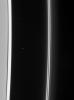 The Cassini spacecraft gazes toward the multiple strands of the ever-changing F ring, also sighting Atlas at its station just beyond the A ring edge. A few faint background stars are visible in the image