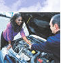 photo: woman and man looking under hood of car