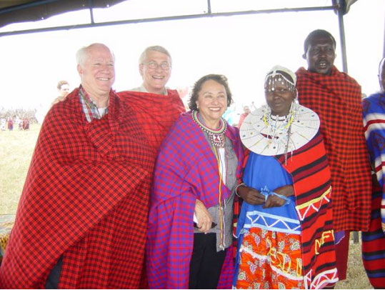 From left to right: Representatives Jim Kolbe of Arizona, Roger Wicker of Mississippi, and Nita Lowey of New York pose with two Maasai elders in Tanzania. The three are garbed in traditional Maasai blankets. (Embassy photo).