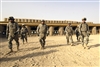 U.S. Army soldiers walk back to the firing line to adjust their sights according to how their shot groups fell on their targets at the shooting range on Forward Operating Base Hawk, Iraq, Aug. 22, 2008. The soldiers are assigned to Comanche Troop, 4th Squadron, 10th Cavalry, 4th Infantry Division. 