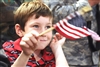 A boy watches President George W. Bush as he makes a speech on Eielson Air Force Base, Alaska, Aug. 4, 2008. 