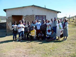 Eastern-Cape community stands before old HIV-AIDS building.