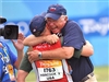 Team USA shotgun coach Lloyd Woodhouse, a retired U.S. Air Force chief master sergeant, hugs U.S. Army Marksmanship Unit member, U.S. Army Pfc. Vincent Hancock after he wins the Olympic gold medal in men's skeet competiton at the Beijing Shooting Range, Aug. 16, 2008. 