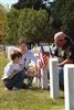 Dakota Linck, 9 years old, left, his mother Debi, and father, Rick, place carnations at the gravesite of their brother and son, Army Staff Sgt. Henry W. Linck, in Arlington National Cemetery on Aug. 24, 2008. The Lincks traveled to Washington from Lebanon, Tenn., to participate in the final day of "Run for the Fallen," a memorial run honoring servicemembers killed while participating in Operation Iraqi Freedom. The run began in California on Flag Day, June 14, 2008. 