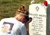 Heather Jutras Glasgow grieves at her brother's grave in Arlington National Cemetery, Aug. 24, 2008. She, her mother, father and younger brother participated in the last day of "Run for the Fallen," a cross-country memorial event to honor troops who died in Operation Iraqi Freedom. 