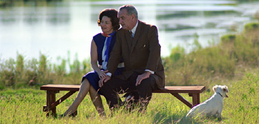 President, Mrs. Johnson and their dog Yuki enjoy sitting near the Pedernales River