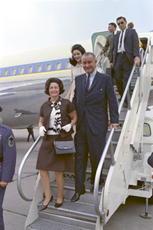 Lady Bird Johnson, President Lyndon B. Johnson, and Lynda Bird Johnson descending steps from Air Force One