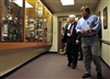 Defense Secretary Robert M. Gates listens to Dr. Greg Fox as he tours the Joint POW/MIA Accounting Command on Hickam AFB, Hawaii, Thursday, Feb. 21, 2008.  