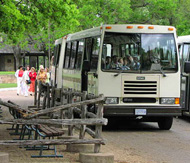 Visitors board a bus for the LBJ Ranch tour