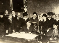 A group of people around a desk.