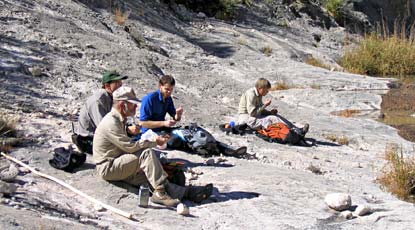 Volunteers take a break during a backcountry hike.