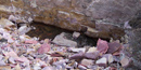 Quarry pit showing the quartzite wall and quartzite rubble pile