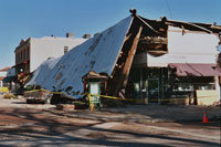 This January 25, 2004 photo shows historic structures and a vehicle damaged in downtown Paso Robles from the 6.5 San Simeon Earthquake.